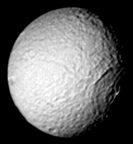 Voyager looks at Tethys, with its huge Crater Odysseus in partial shadow.