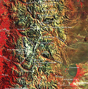 The narrowed Andes fold belt in northern Chile; note that the east side of the Andes is desert-like whereas the Altiplano (high plains) on the west side is heavily forested, with grasslands (but to its west at lower altitudes the rain shadow effect as moisture is precipitated out by orographic rise of air over the mountains; note also the band of vegetation at the lower edge of two alluvial fans, which results from water flowing through the alluvium and emerging to nourish local natural vegetation.